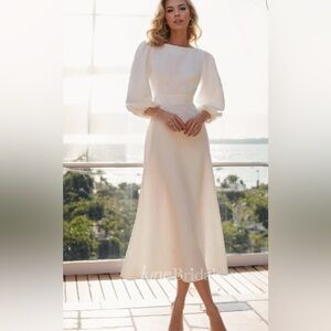 Never worn, with tags ivory a-line midi dress with billow sleeve. Size 6.